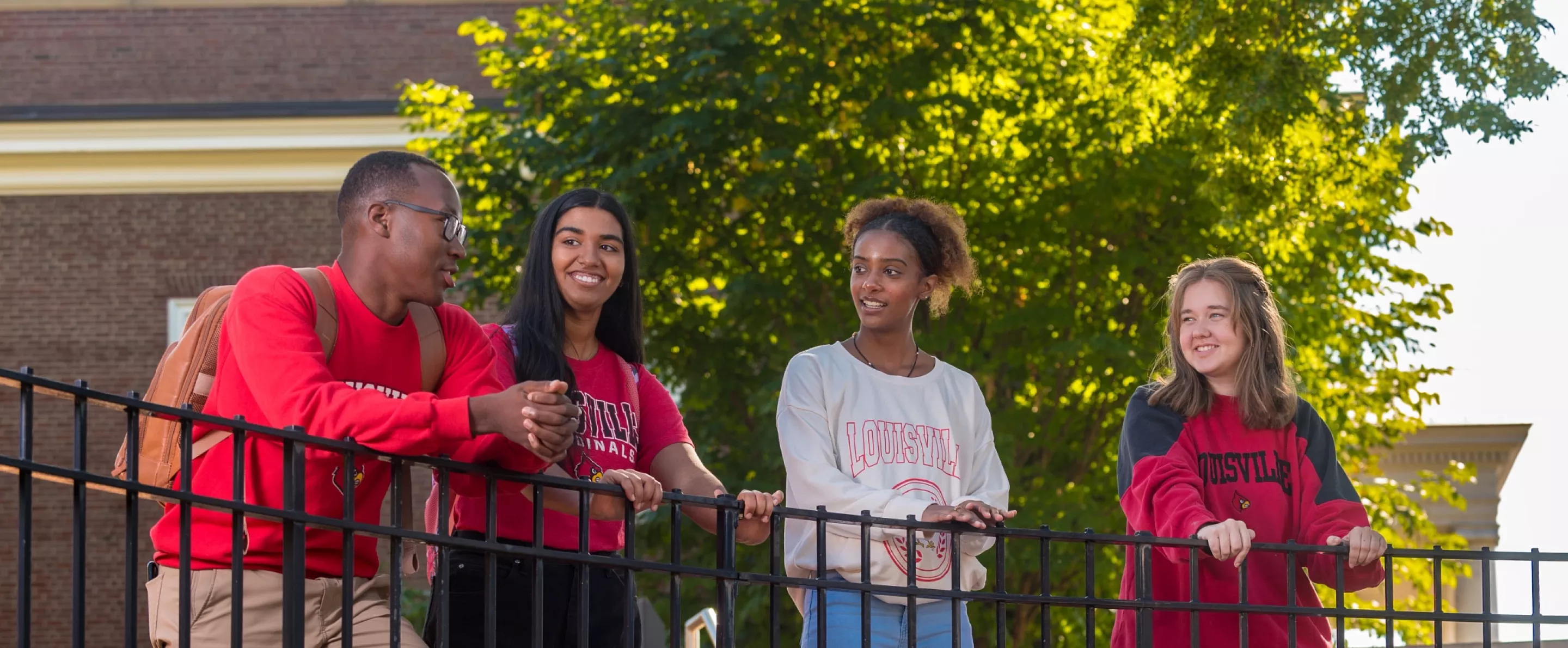 A group of students talking on campus