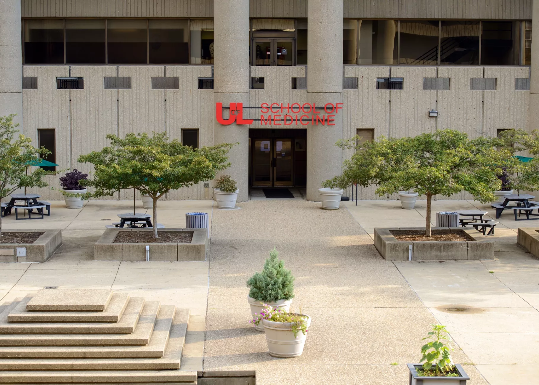 HSC courtyard with University of Louisville School of Medicine sign.