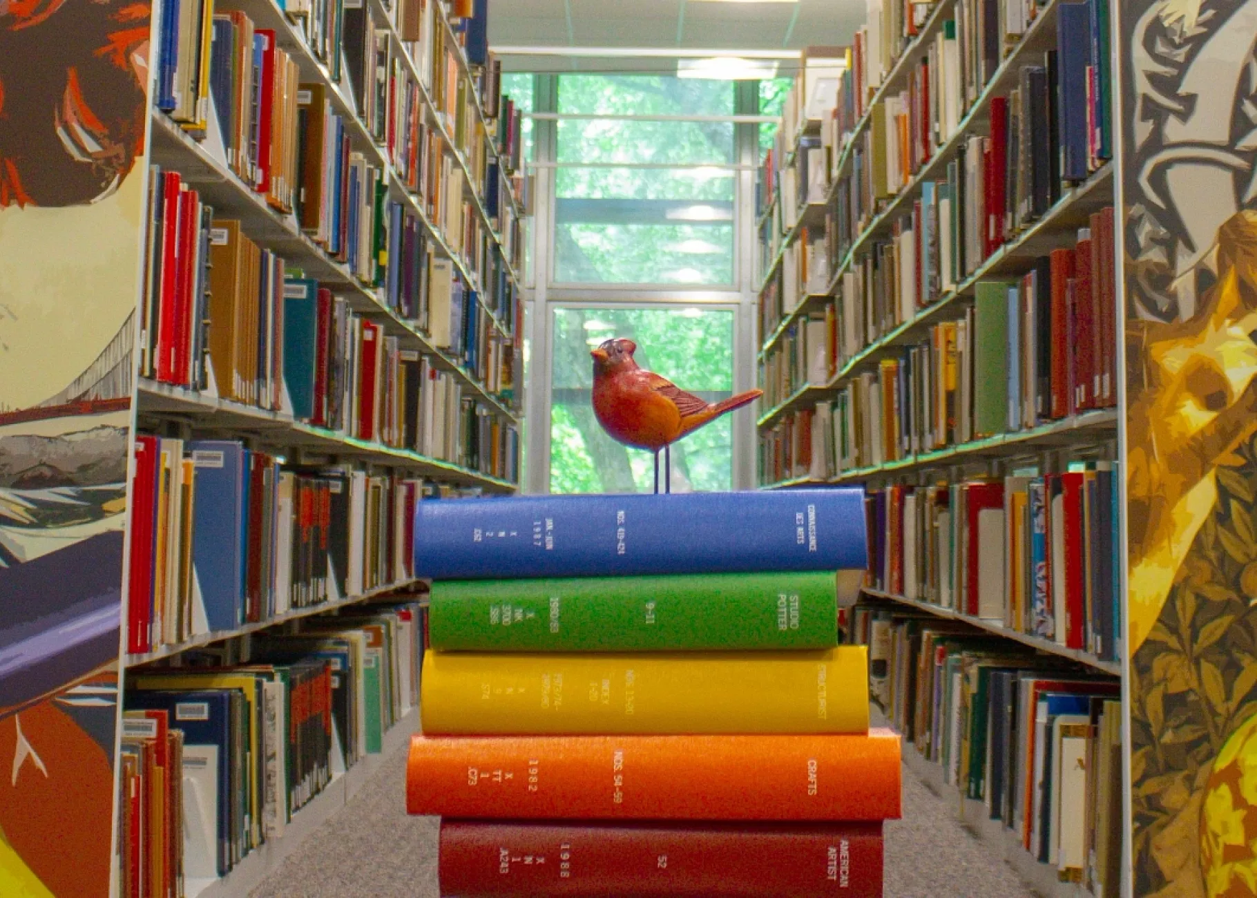 rows of library shelves decorated with vibrant artwork