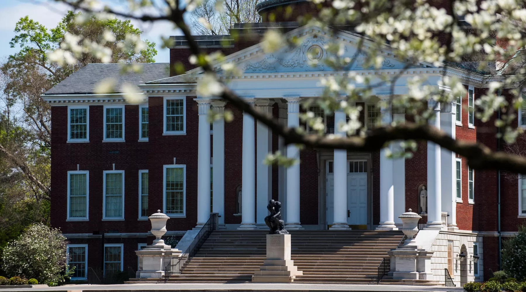 Exterior of Grawemeyer Hall with spring trees in bloom