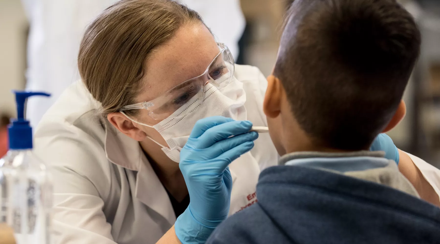 Dental student gives young boy a dental exam