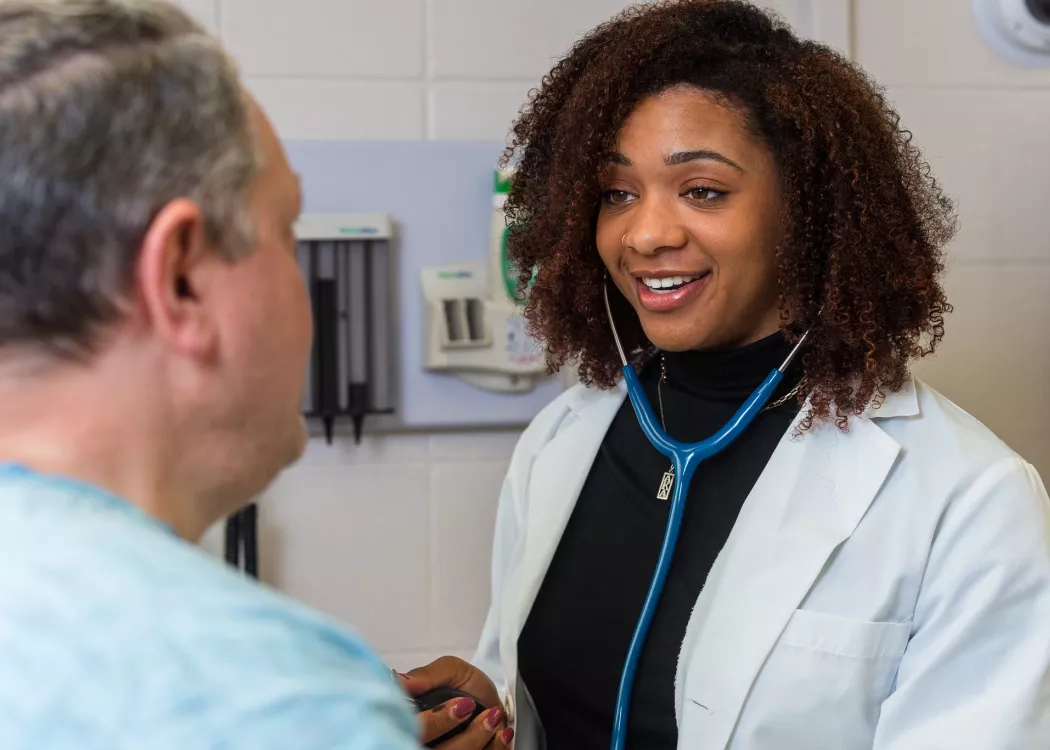 Medical student Michaela Carter works with a standarized patient.