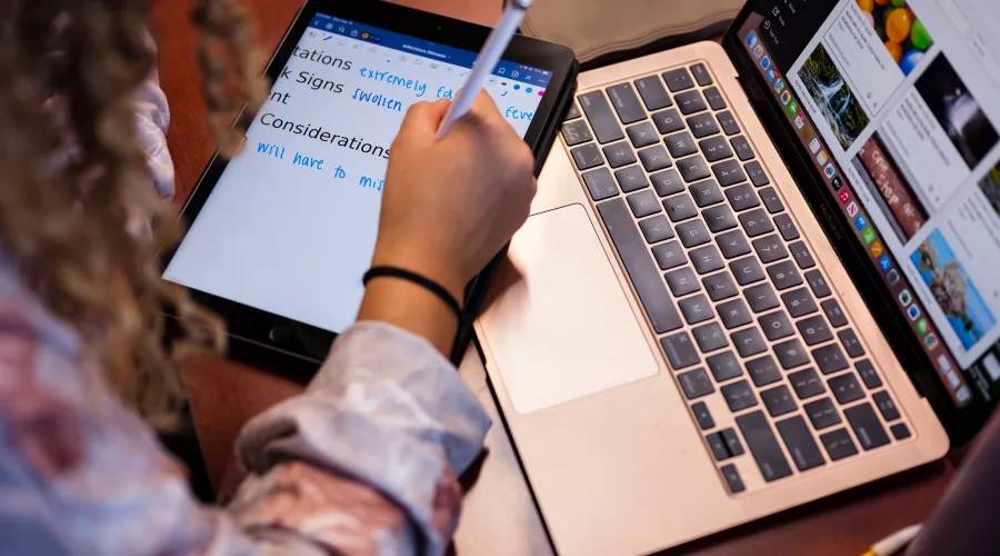 Students in a nursing lecture listening and taking notes.