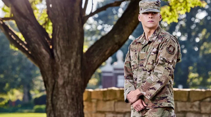 Brimm is pictured in his army uniform, in the at ease position, on the university campus.