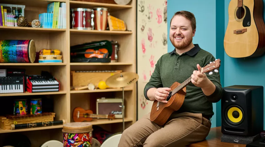 Portrait of Andrew Chapman in a music classroom environment