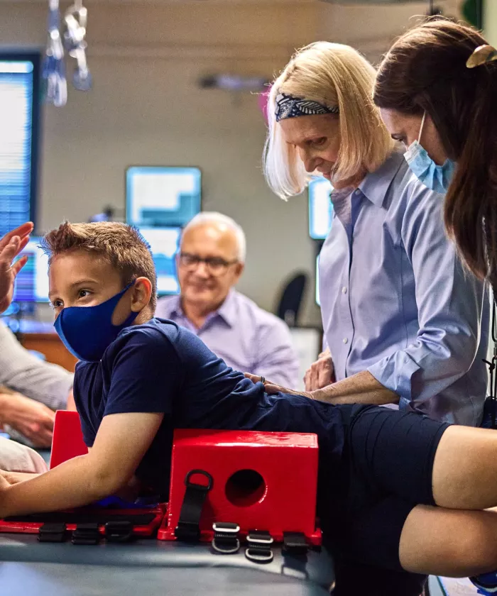 Andrea Behrman is doing research on and analyzing a child's spinal cord.